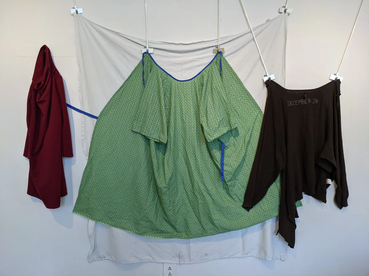 A Bad Year — installation of garments hung on a line against a white wall